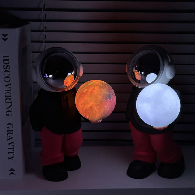 Holding the romantic moon grey top + navy blue pants Creative Astronaut Bluetooth Speaker with 3D Starry Sky Lighting, Portable Wireless Moon Lamp Speaker - Perfect Gift for Space Enthusiasts