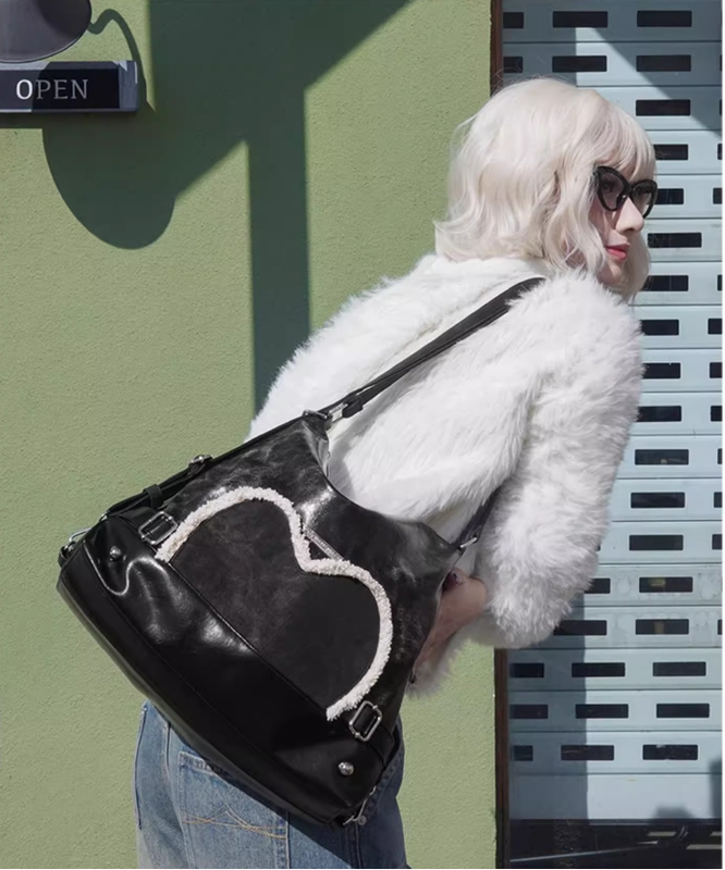 Stylish black tote backpack with heart embellishment - can be worn on one shoulder or as a backpack