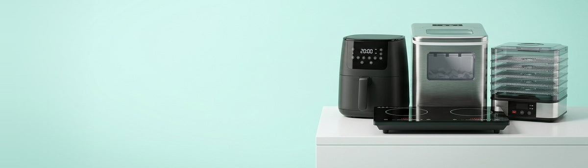Kitchen appliances hero: air fryer, induction cooktop, ice maker and dehydrator on mint